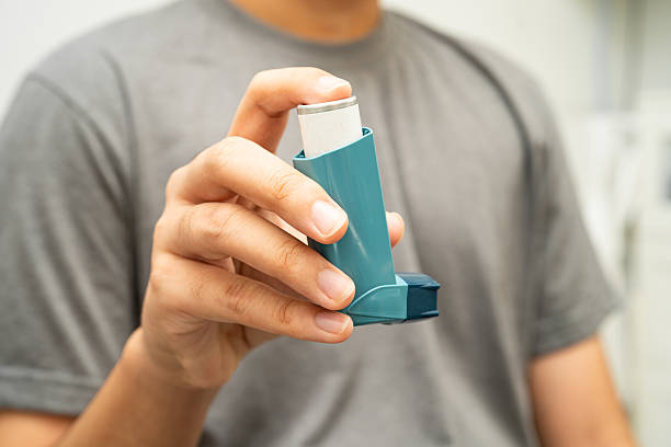 istock Asthma and chronic obstructive pulmonary disease COPD, Asian young man using metered dose inhaler MDI. 2241143113
