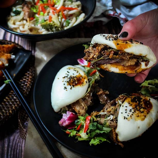 istock Bao buns on dark plate with chopstick and rustic background 2241145078