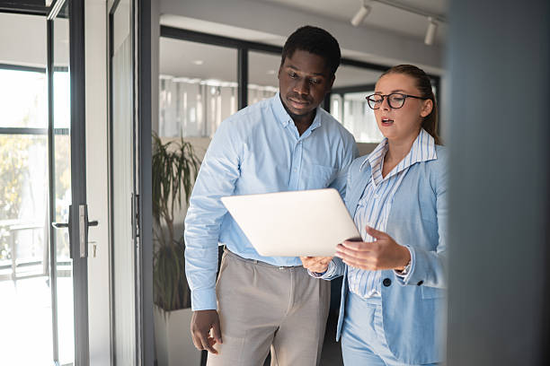 istock Two business colleagues collaborating on laptop in modern office 2241146258