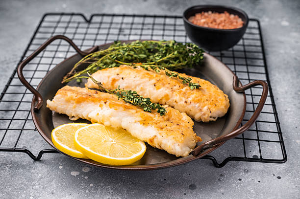 istock Baked Cod fish fiilet, fried whitefish meat. Grey background. top view 2241146788