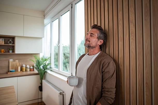 istock Mature man relaxing at home, enjoying morning coffee in kitchen 2241146938