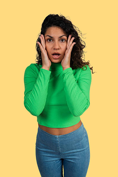 istock Young woman having shocked expression with hands on face 2241148135