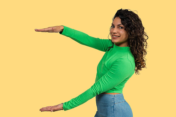 istock Woman presenting and smiling comparing size with arms 2241148355