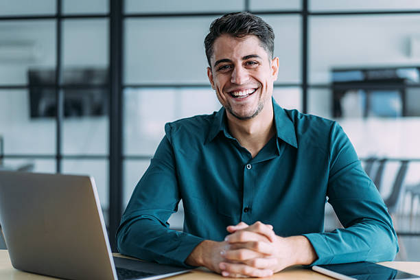 istock Successful businessman in modern office working on laptop. 2241148492
