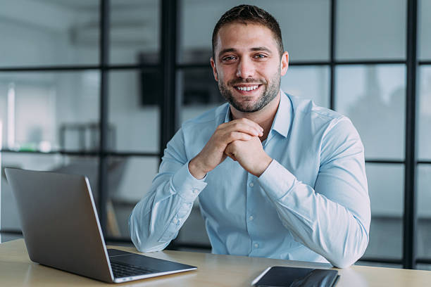 istock Successful businessman in modern office working on laptop. 2241148496