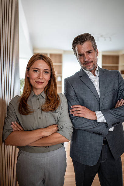 istock Business partners standing together with arms crossed 2241148694