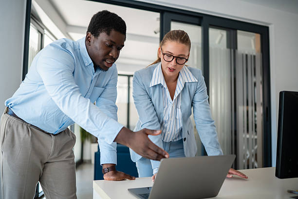 istock Business colleagues discussing ideas while working on laptop in modern office 2241148887