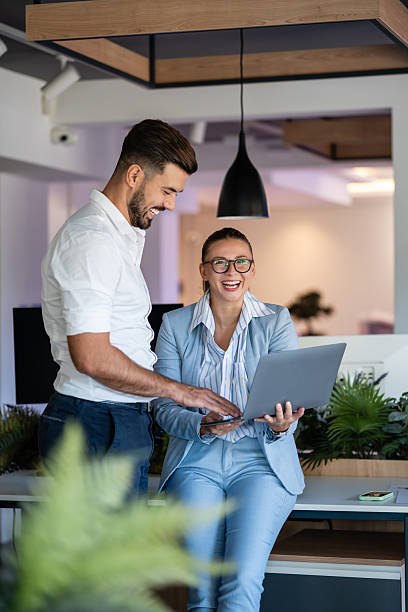 istock Happy business colleagues collaborating in modern office workspace 2241149047
