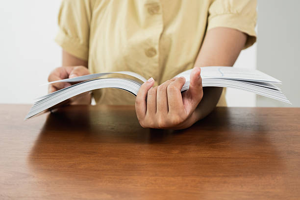 istock Reading a book at home personal activity indoor setting intimate viewpoint learning and relaxation concept 2241149381