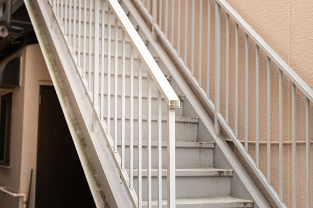 Iron pedestrian stair walkway outside the building for walking up to upper level floor. Building place object with selective focus.
