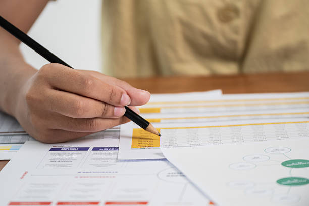 istock Analyzing business strategies with graphs and charts office setting document review professional environment close-up view 2241150036