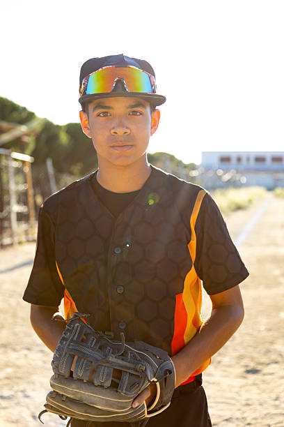 istock Young baseball player holding glove on field 2241150193