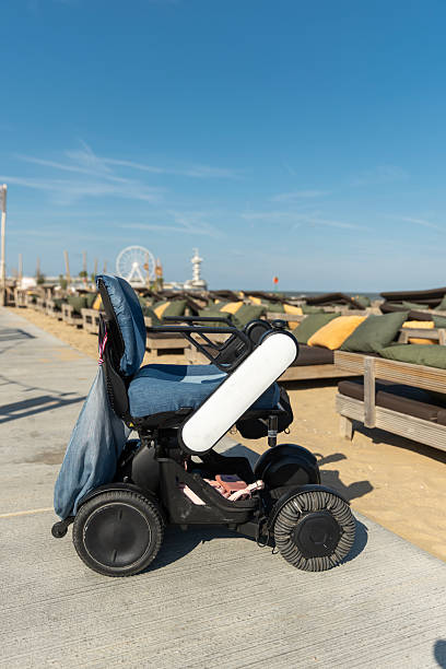 istock Empty wheelchair at the beach 2241151115
