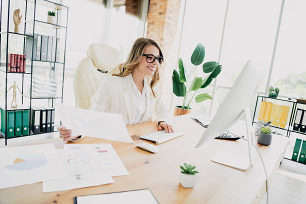 istock Professional businesswoman working in an elegant modern office with computer and charts, emphasizing productivity and success 2241152957
