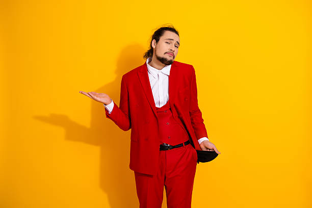 istock Red suited man strikes a playful pose in a bright yellow studio creating a bold fashion moment for advertising and celebration with retro style and modern glamour 2241155598