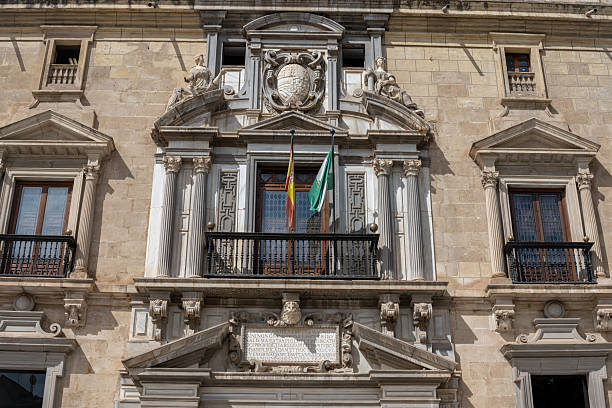 View of the Courthouse of Granada, Spain, featuring classic architectural details and sunny Andalusian atmosphere. Perfect image for concepts of justice, law, institutions, and cultural tourism.