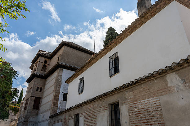 Exterior view of the Monastery of Santa Isabel la Real in Granada, Spain, featuring historic Andalusian architecture and a religious atmosphere. Perfect image for concepts of history, culture, religion, tourism, and architectural heritage.