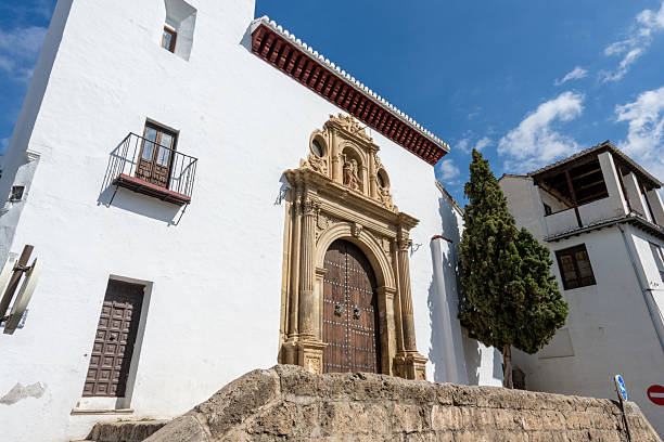 Exterior view of the Monastery of Santa Isabel la Real in Granada, Spain, featuring historic Andalusian architecture and a religious atmosphere. Perfect image for concepts of history, culture, religion, tourism, and architectural heritage.