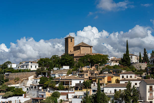 Aerial view of the city of Granada, Spain, showcasing the historic center, the Cathedral, the Alhambra, and characteristic Andalusian neighborhoods. Perfect image for urban landscape, tourism, culture, and architecture concepts.