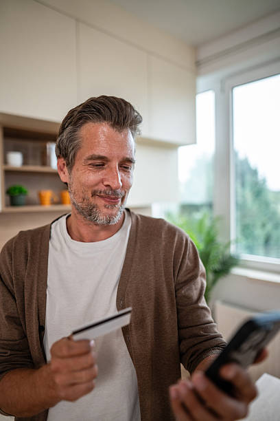 istock Man shopping online using credit card and smartphone 2241157005
