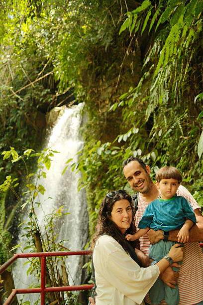 istock Family enjoying vacation exploring nature near waterfall 2241157984