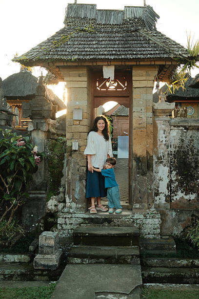 istock Mother and son visiting Balinese temple gate at sunset 2241157996