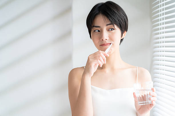 istock a woman brushing her teeth 2241158134