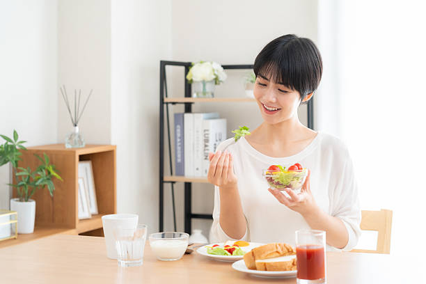 istock woman eating 2241158240