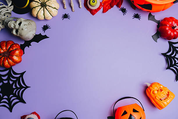 istock Halloween concept. Creative Halloween Background with Pumpkins, Spiders, and Unique Decorations on Purple Surface for Spooky Atmosphere 2241159026