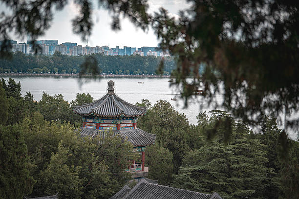 China, Beijing - September 22, 2025 : An ancient building stands within the Summer Palace, showing architectural details. A tranquil scene unfolds with lake and trees.