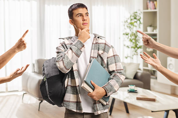 istock Male student with backpack and books standing and thinking 2241160629