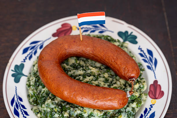 istock Traditional Dutch Dish Stamppot Boerenkool met Worst, Mashed Potatoes with Kale, Smoked Sausage, and Gravy 2241160650
