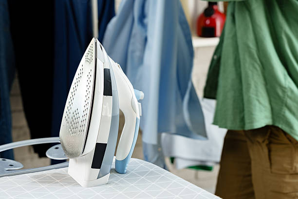 istock Ironing clothes in a well-lit laundry room for a fresh look and tidy appearance 2241160813