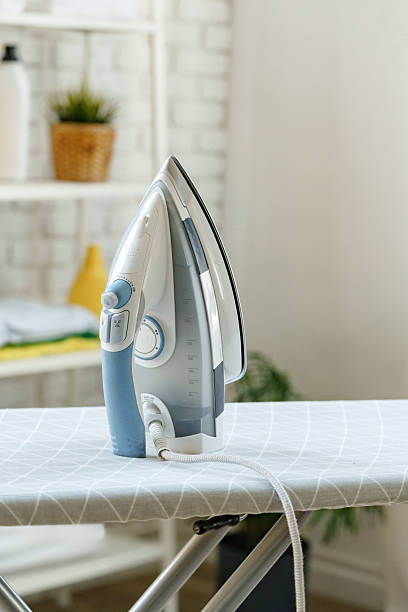 istock Iron resting on an ironing board in a bright, organized laundry area with natural light 2241160817