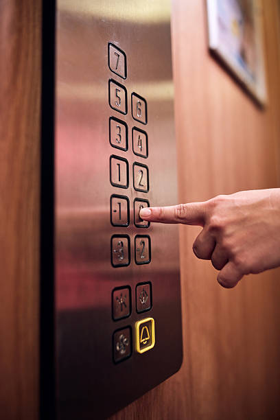 istock Person pressing elevator buttons in the building. 2241161338