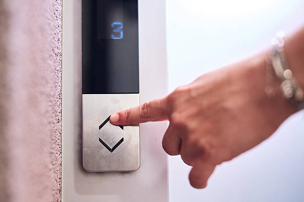 istock Person pressing elevator buttons in the building. 2241161354