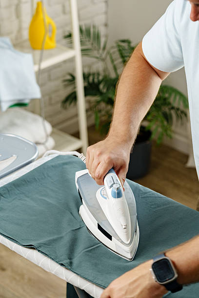 istock Ironing a blue shirt at home on a weekday morning 2241162044