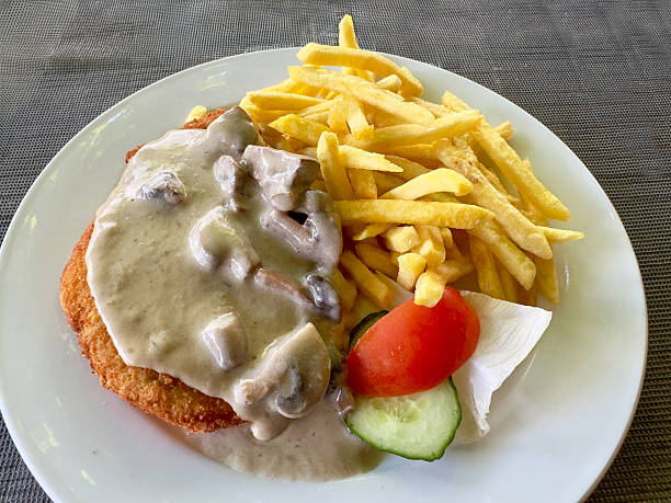 Pork schnitzel with a mushroom sauce and fries