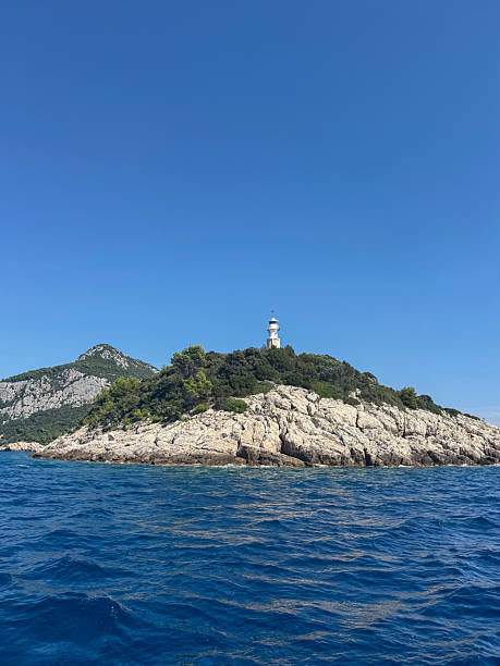 istock island in the sea with lighthouse 2241164836