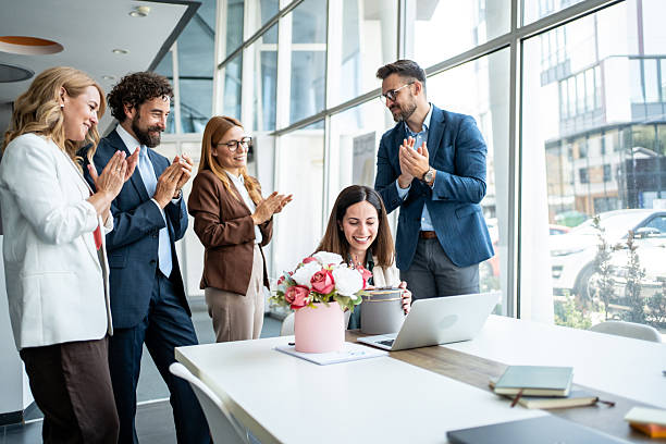 istock Colleagues celebrating recognition with applause and gift in office 2241165522