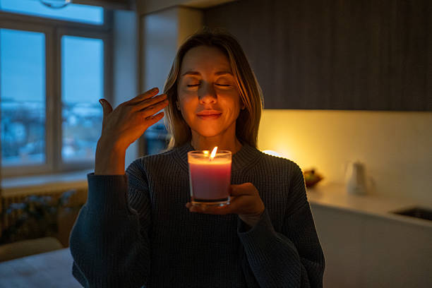 istock Pleased calm woman practicing evening relaxation with aromatic candle meditating, reliving stress. 2241166930