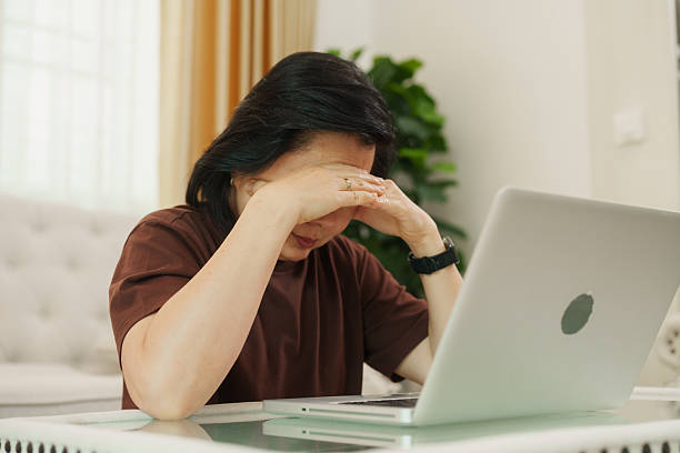 istock Elderly woman feeling anxious while trying to complete work on her laptop at home 2241167123