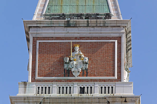 Detail of arched marble decoration with porphyry inlays and saints on the facade of St. Mark's Basilica, Venice, Italy.