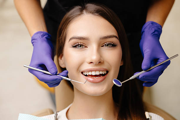 istock Happy patient during a visit to the dentist. The doctor is checking teeth using a dental instrument, ensuring proper oral care in the dentistry clinic 2241170864