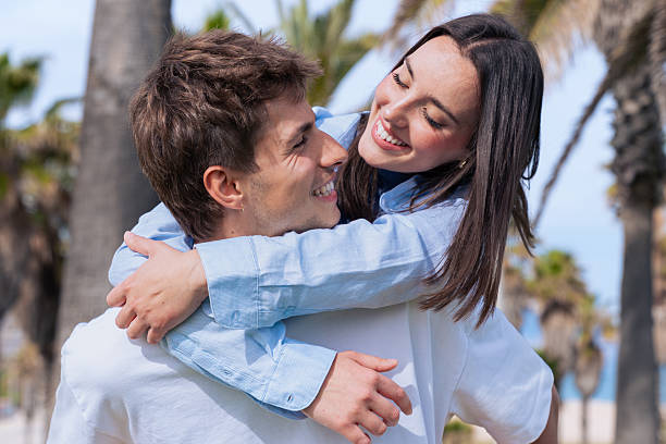 istock Young couple outdoors smiling and hugging together in romantic moment 2241172770