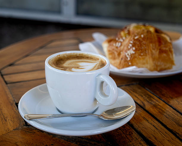 istock White coffee cup with a spoon on a wooden table 2241175002