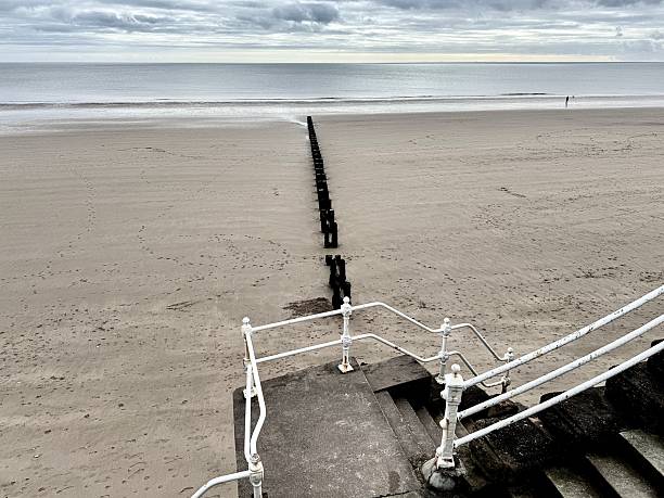 istock Steps and a white railing leading to the beach at Bridlington 2241175375
