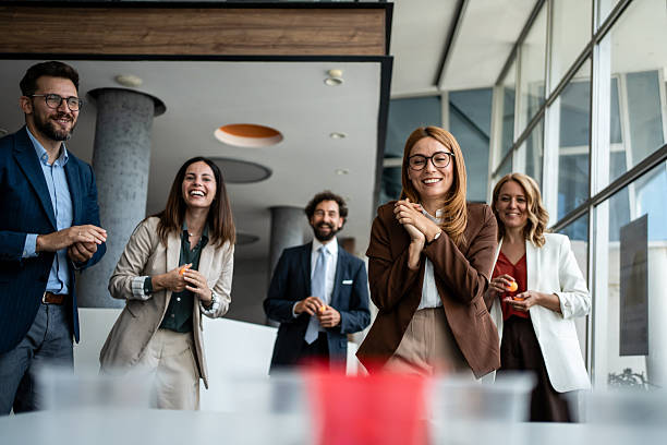 istock Business colleagues playing office beer pong game having fun 2241176860
