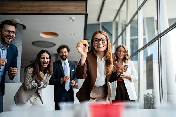 istock Colleagues playing office beer pong during team building event 2241176872