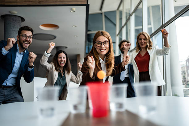 istock Business colleagues playing office beer pong game having fun 2241176923